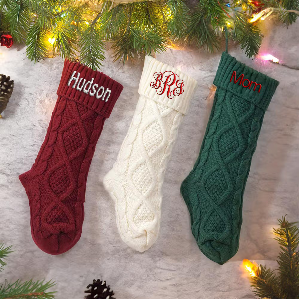 Red, green and white cable-knit stocking with names