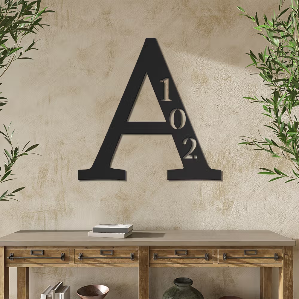 Black metal sign with initial A and house-number 102